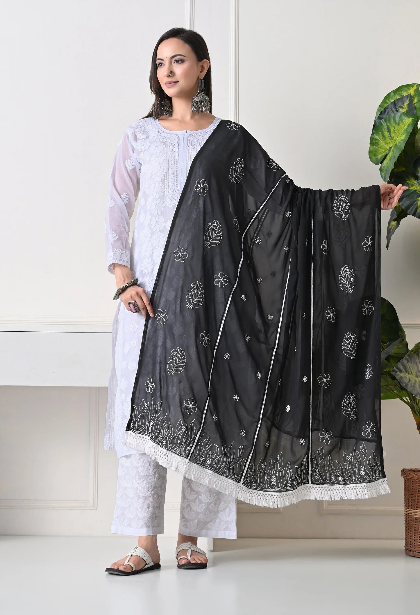 Front view of Woman wearing a black dupatta with a white background