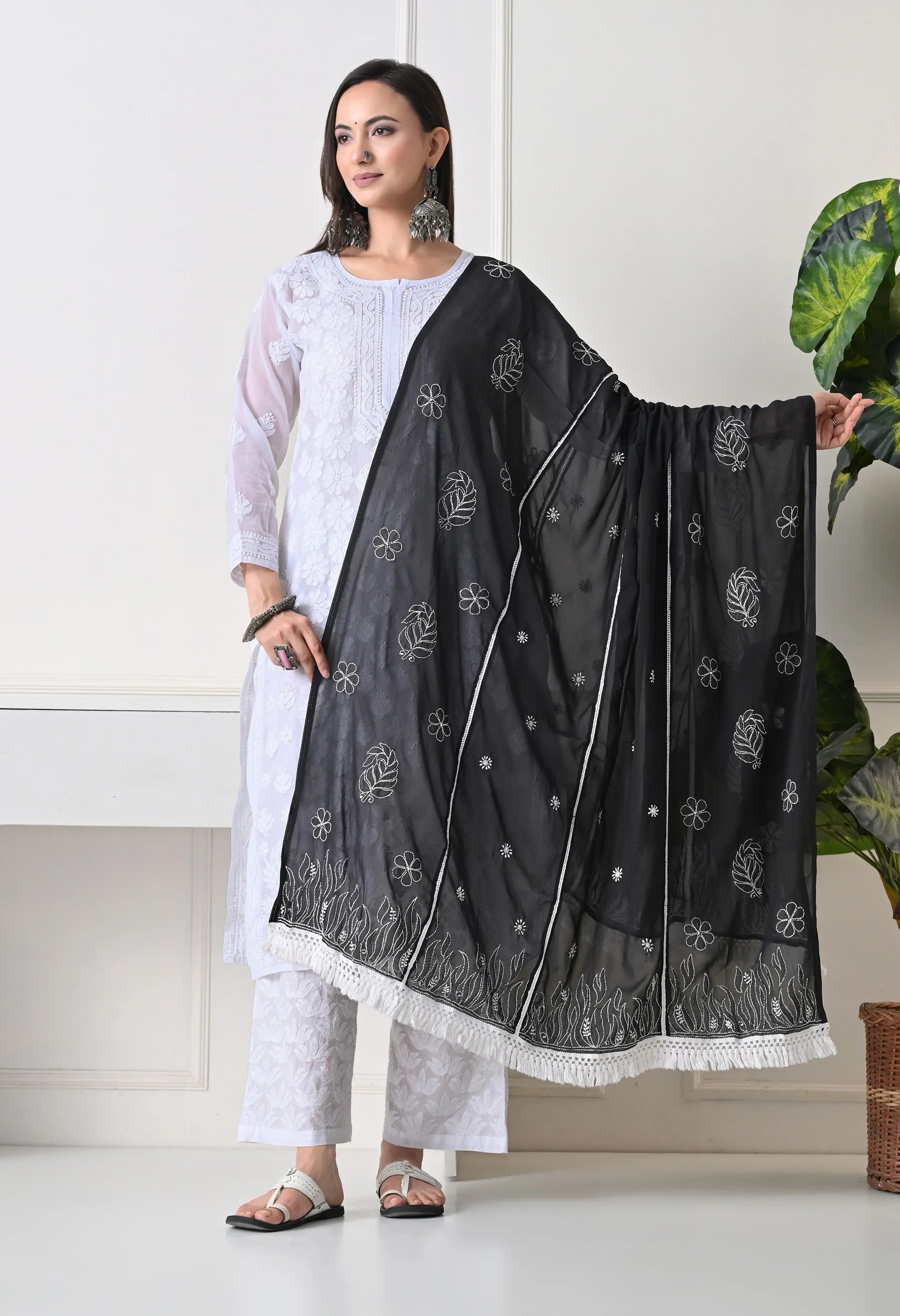 Front view of Woman wearing a black dupatta with a white background