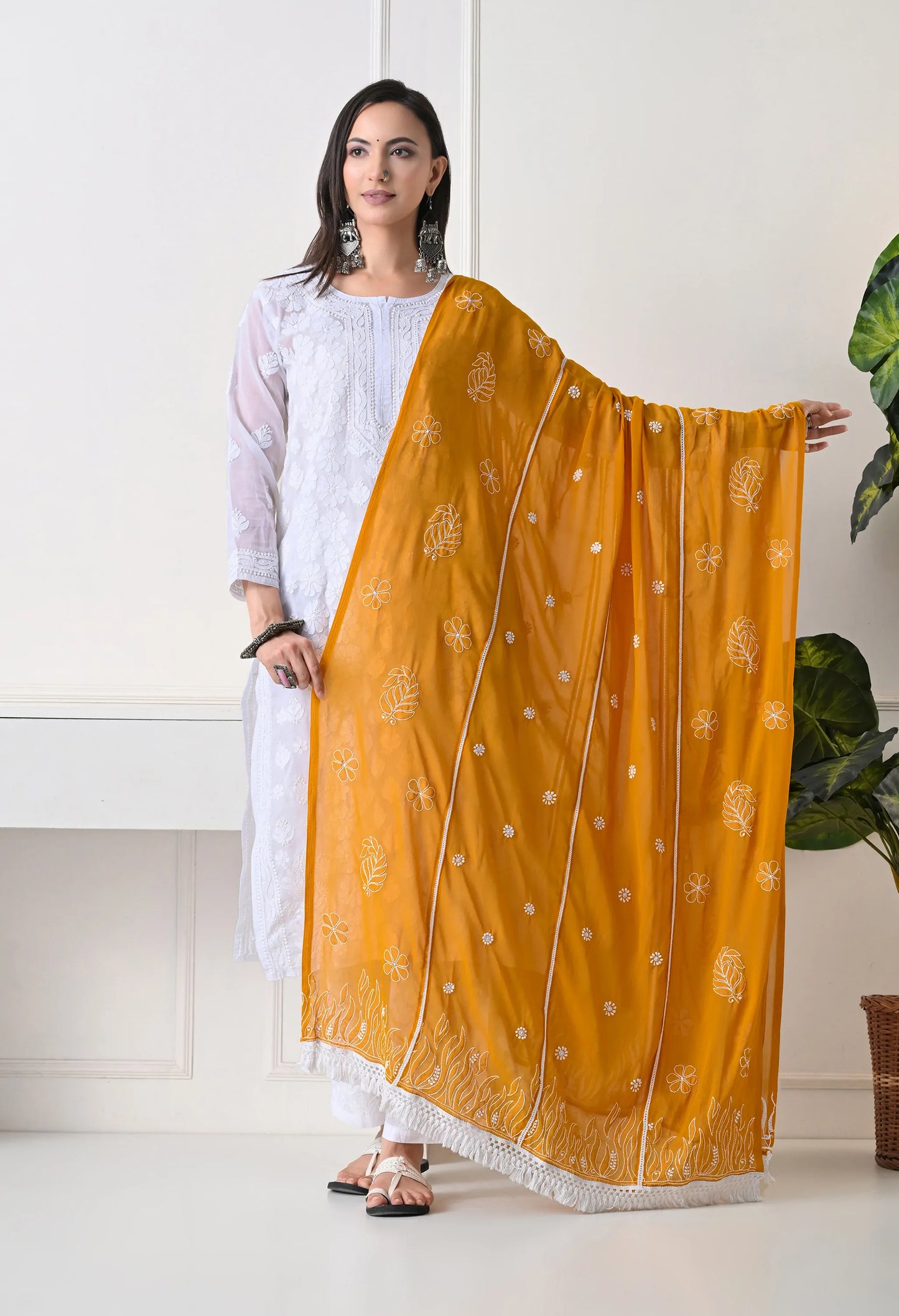 Mustard embroidered dupatta on traditional white outfit with white pants on a neutral background