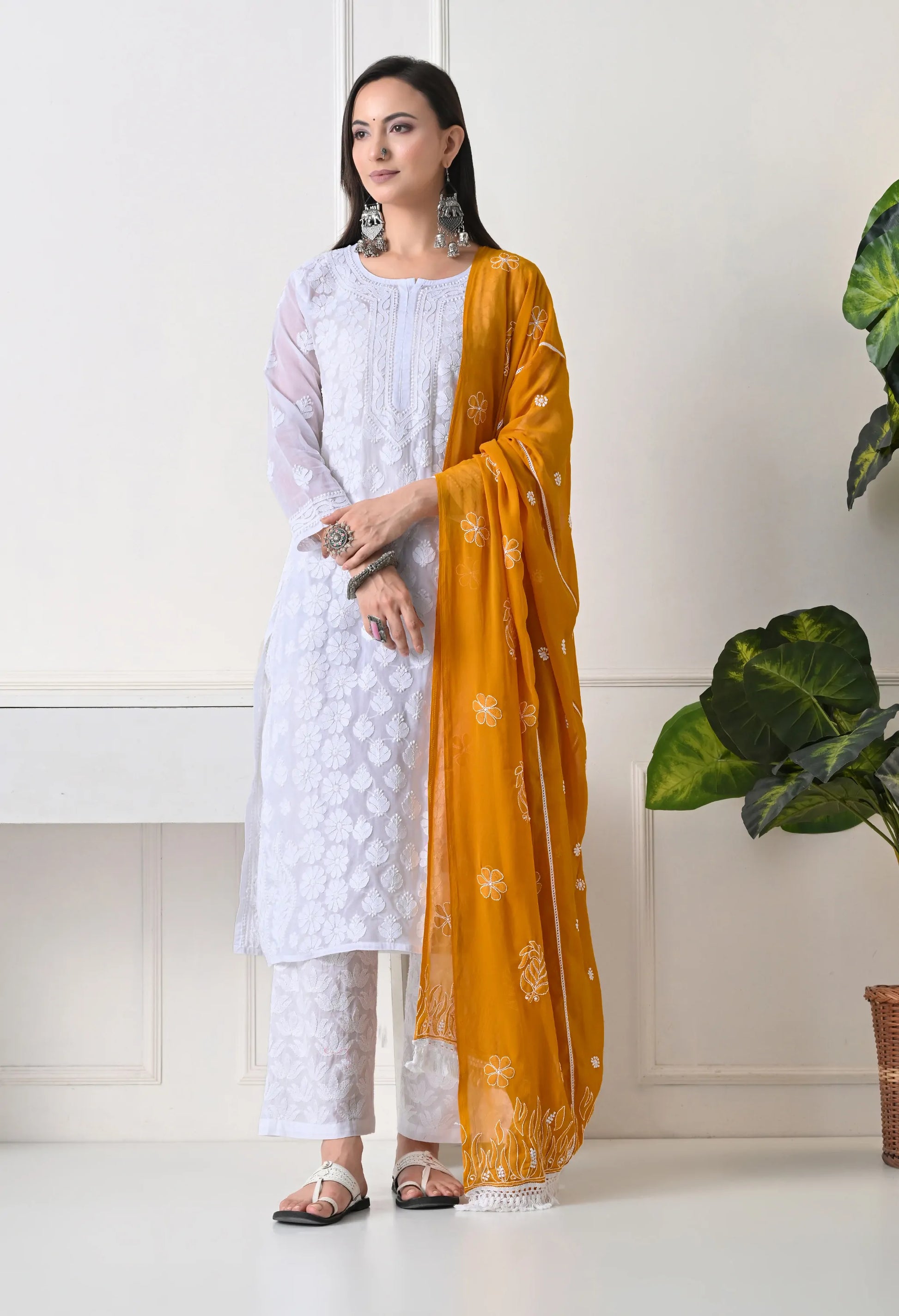 Mustard embroidered dupatta on traditional white outfit with white pants on a neutral background simple view