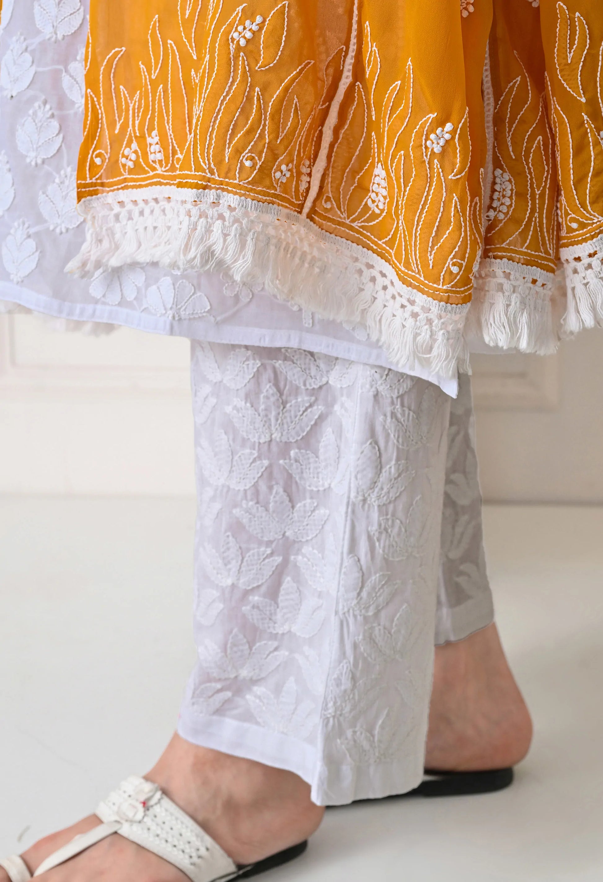 Mustard embroidered dupatta with a yellow and white patterned top on a white background