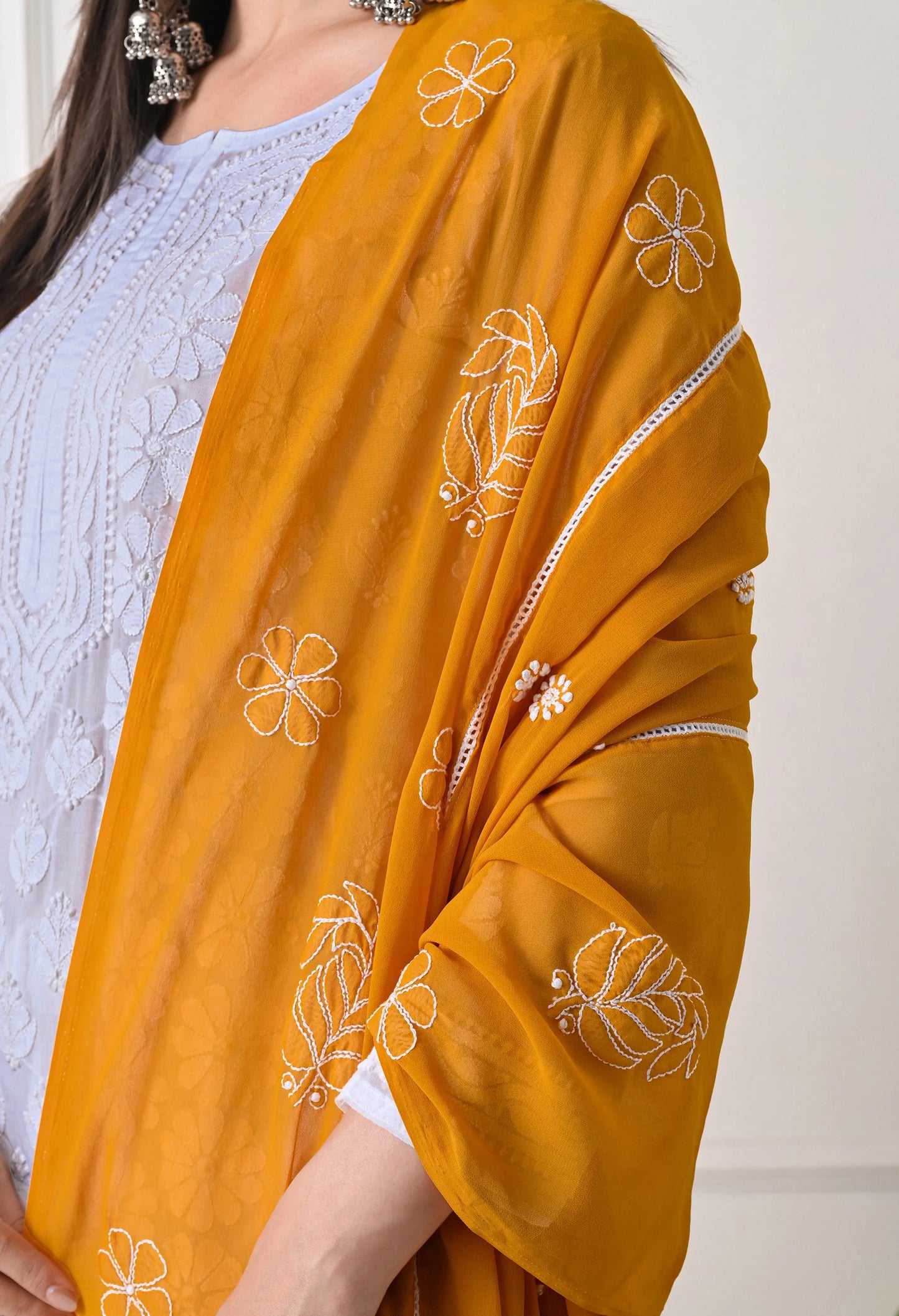 Mustard yellow dupatta with floral embroidery on a white background