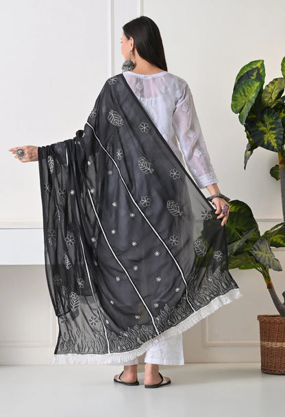 Woman wearing a black dupatta with a white background