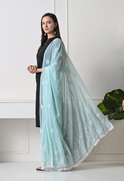 Woman wearing a light blue dupatta with a white background