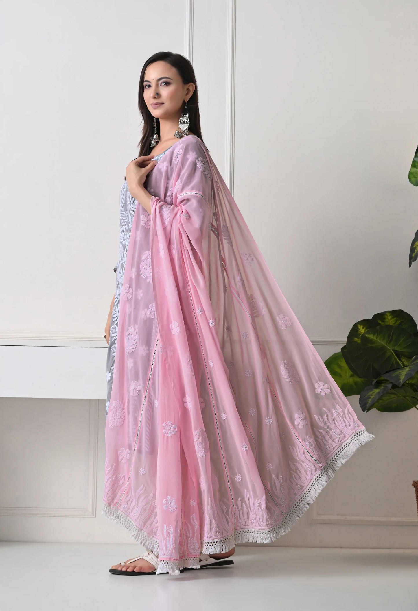 Woman wearing a pink dupatta with a white background