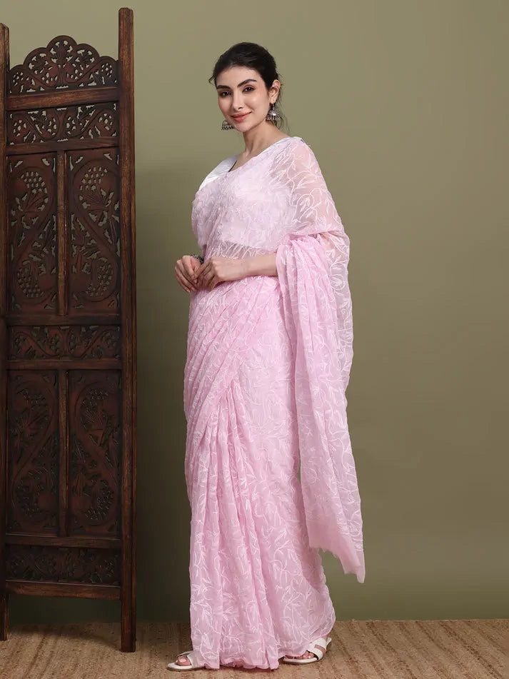 Angled view of exclusive baby pink hand-embroidered Tepchi Chikankari saree