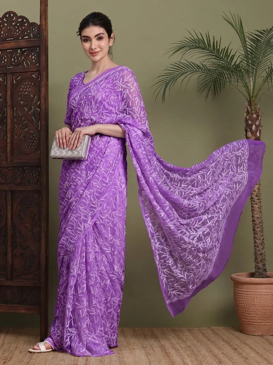 Lifestyle view of women wearing exclusive Dark Purple Tepchi hand-made Chikankari saree