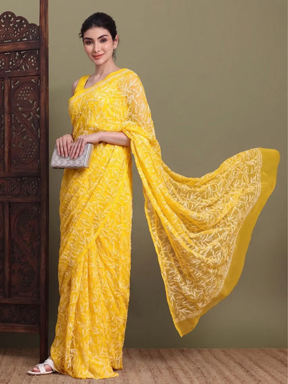 Angled view of exclusive dark yellow Tepchi hand-made Chikankari saree for women