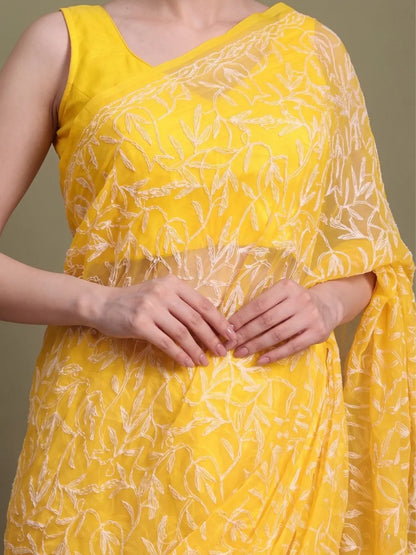 Closeup view of exclusive dark yellow Tepchi hand-made Chikankari saree for women