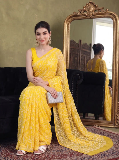 Seated view of exclusive dark yellow Tepchi hand-made Chikankari saree for women