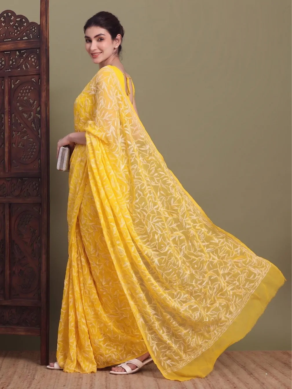 Side view of exclusive dark yellow Tepchi hand-made Chikankari saree for women