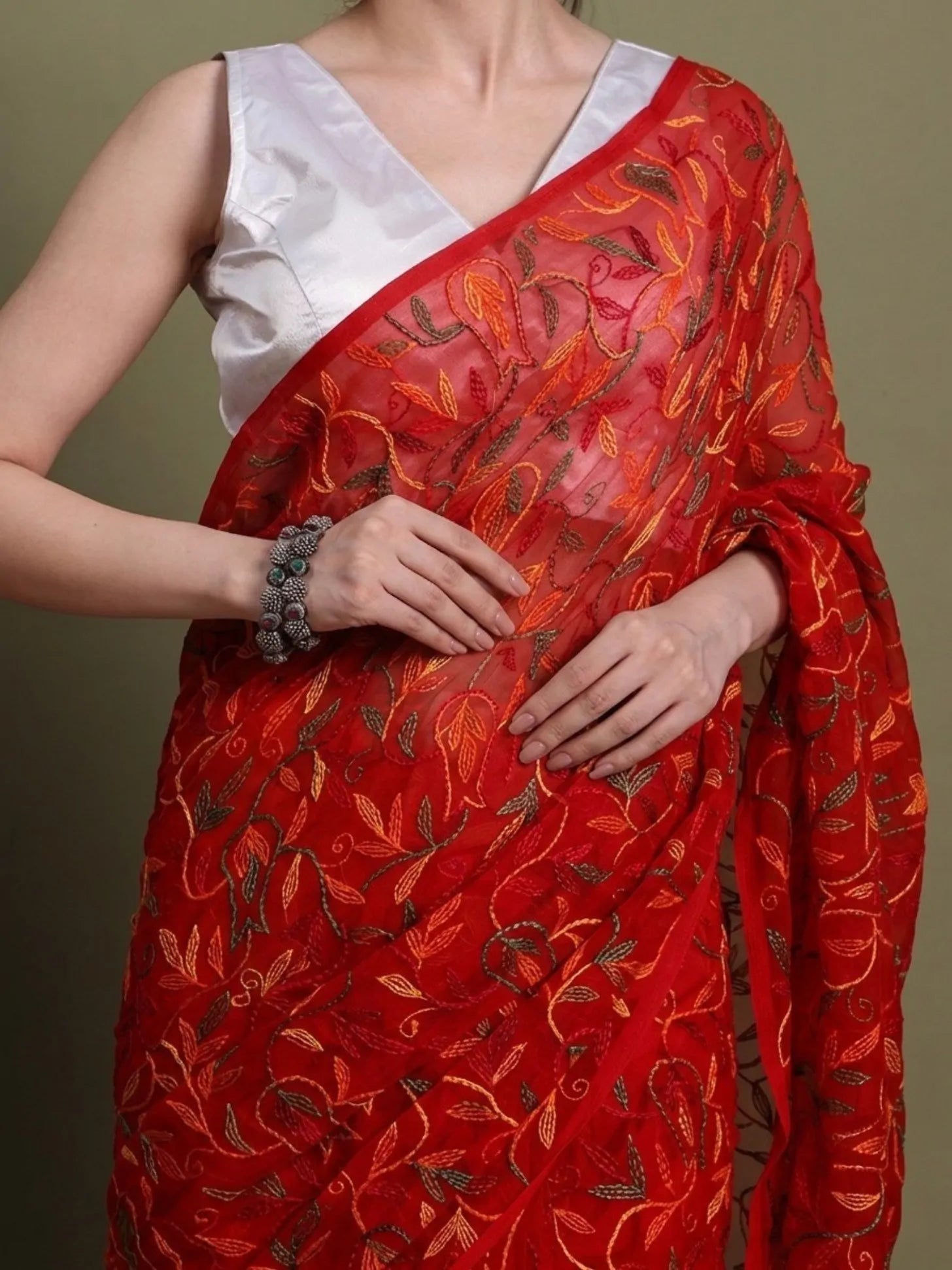 Closeup view of exclusive multi red Tepchi hand-made Chikankari saree for women