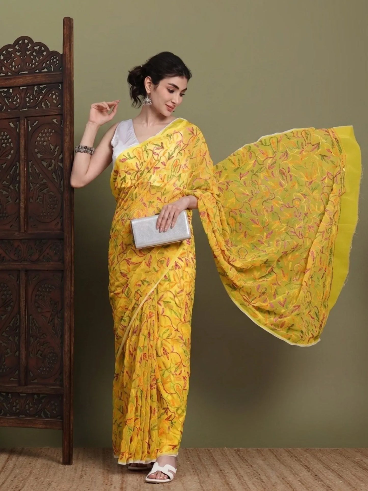 Angled view of exclusive multi yellow Tepchi hand-made Chikankari saree for women