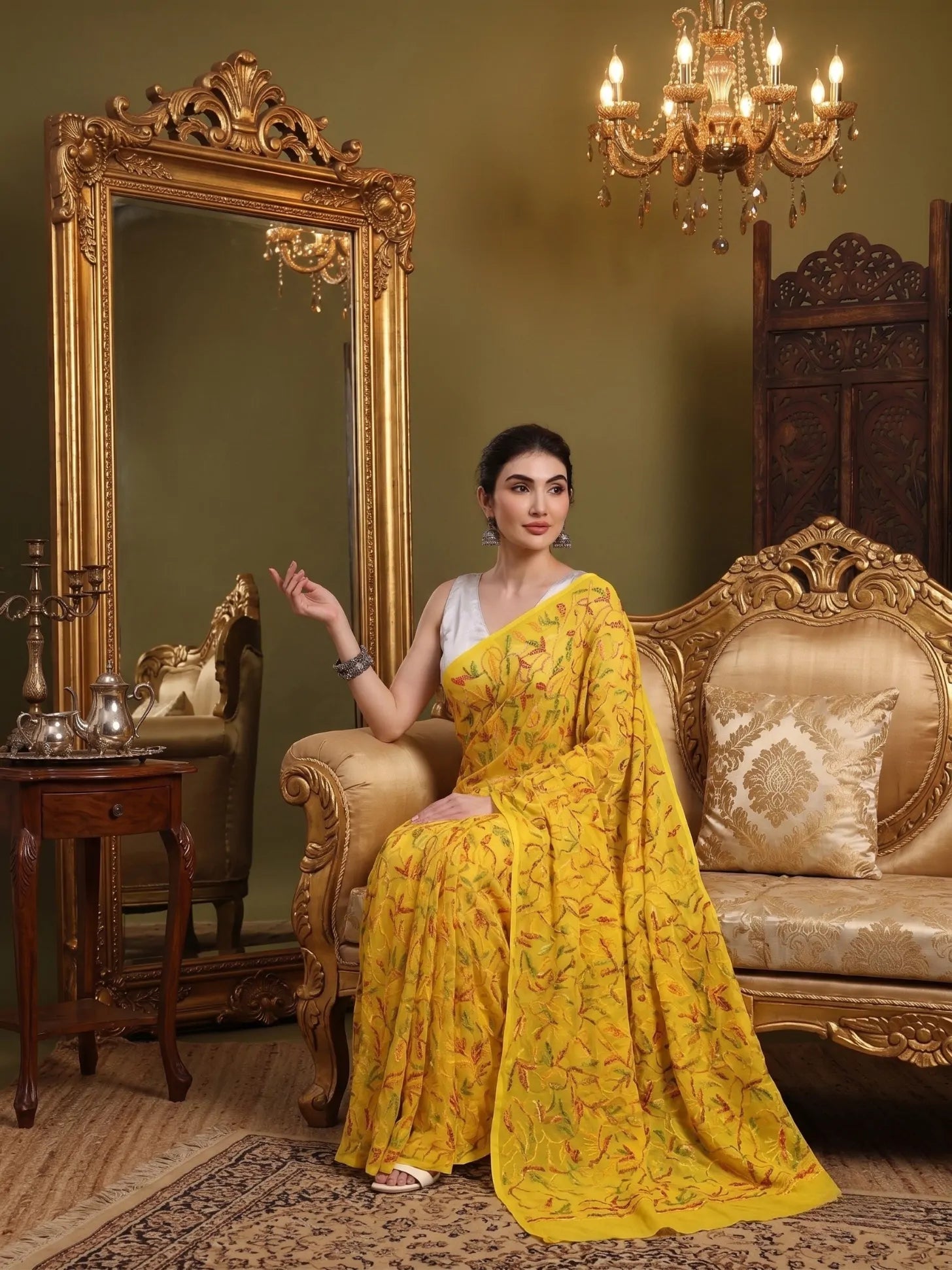 Seated view of exclusive multi yellow Tepchi hand-made Chikankari saree for women