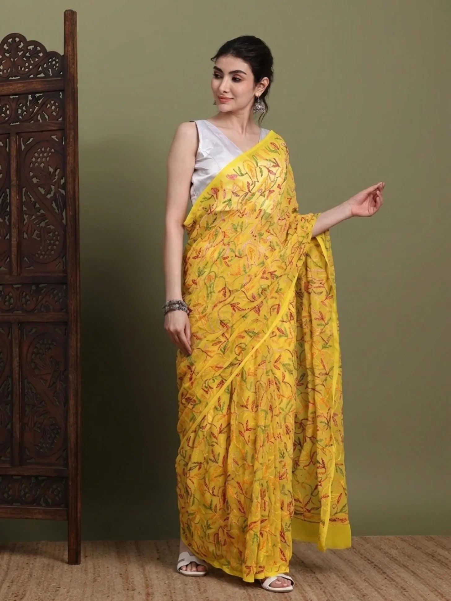 Side view of exclusive multi yellow Tepchi hand-made Chikankari saree for women