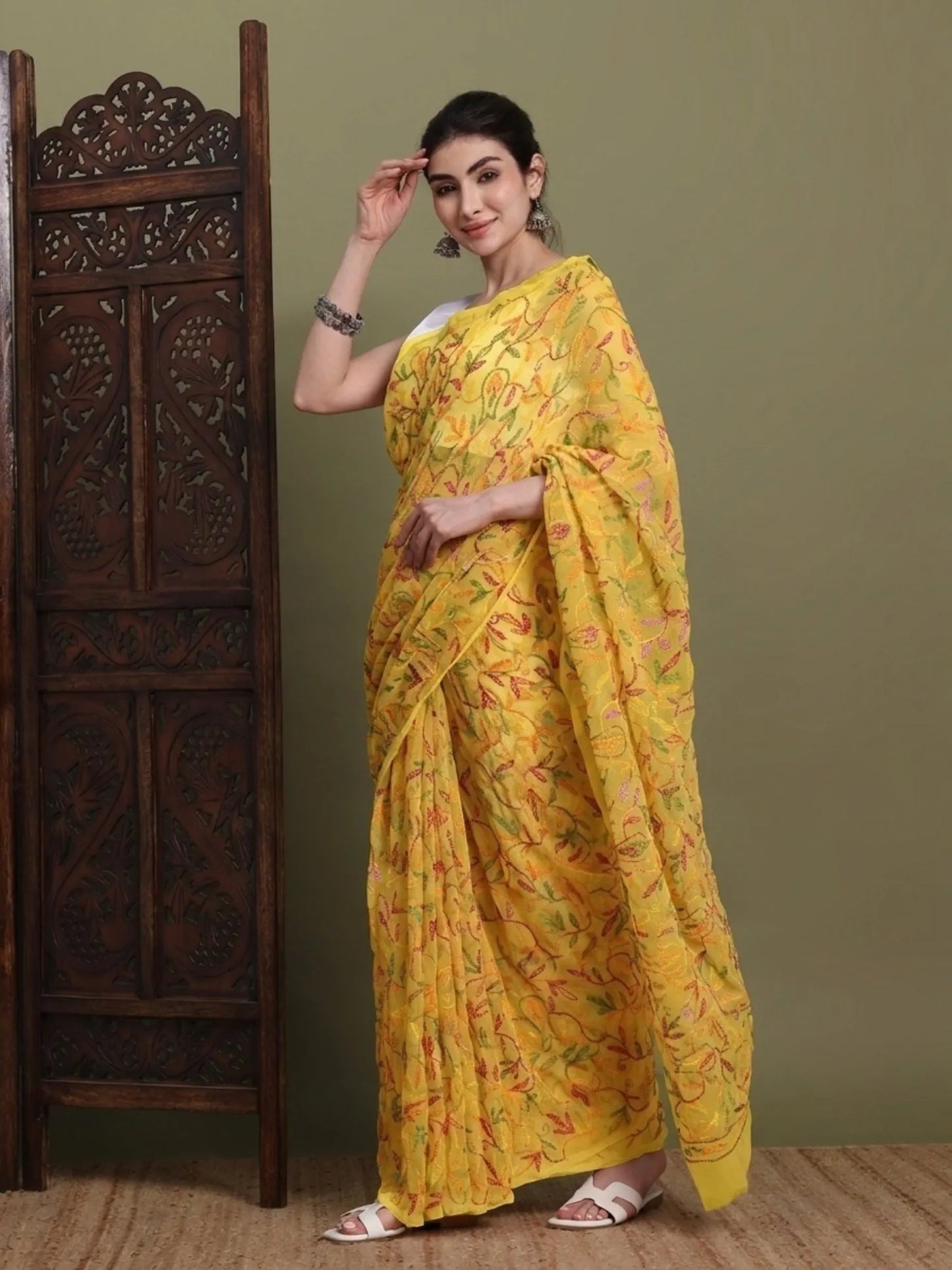 Sided view of exclusive multi yellow Tepchi hand-made Chikankari saree for women
