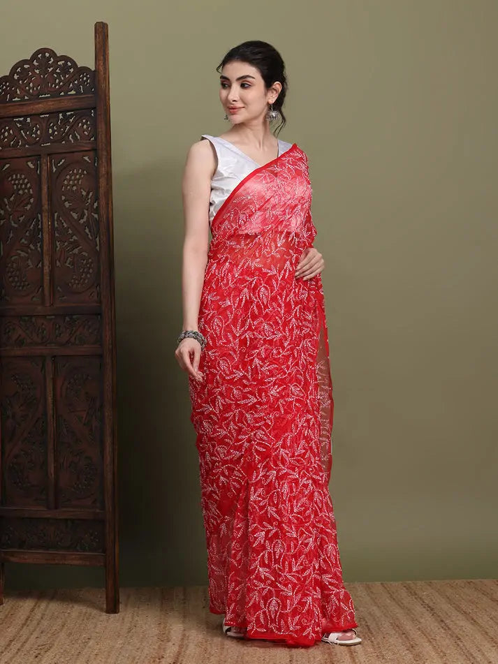 Side profile view of exclusive red Tepchi Chikankari saree