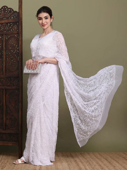 Lifestyle view of women wearing exclusive white Tepchi hand-made Chikankari saree