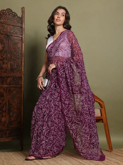 Lifestyle view of women wearing exclusive wine Tepchi hand-made Chikankari saree