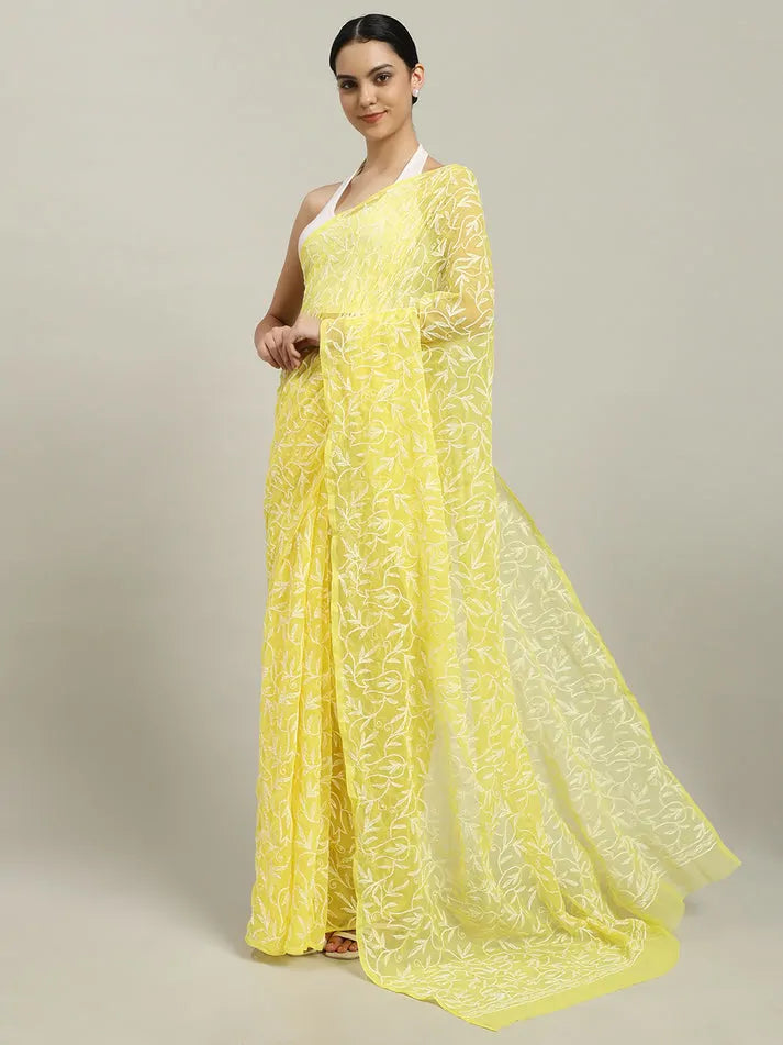 Angled view of exclusive yellow hand-embroidered Tepchi Chikankari saree