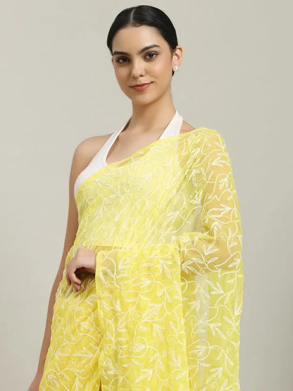 lose-up embroidery detail of exclusive yellow hand-crafted Tepchi Chikankari saree
