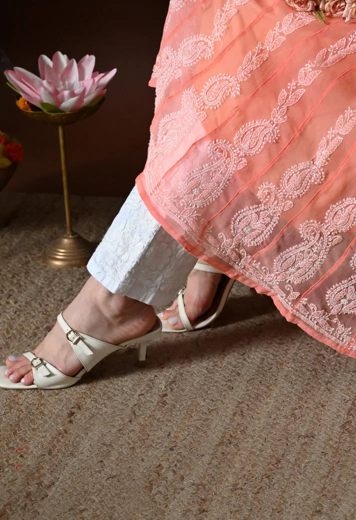 Close up of embroidered hemline and border detail on peach anarkali kurta