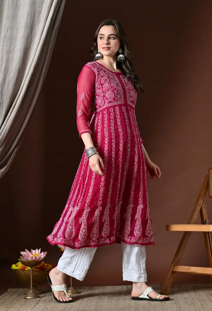 Angled view of pink cotton anarkali kurta with white pants for women