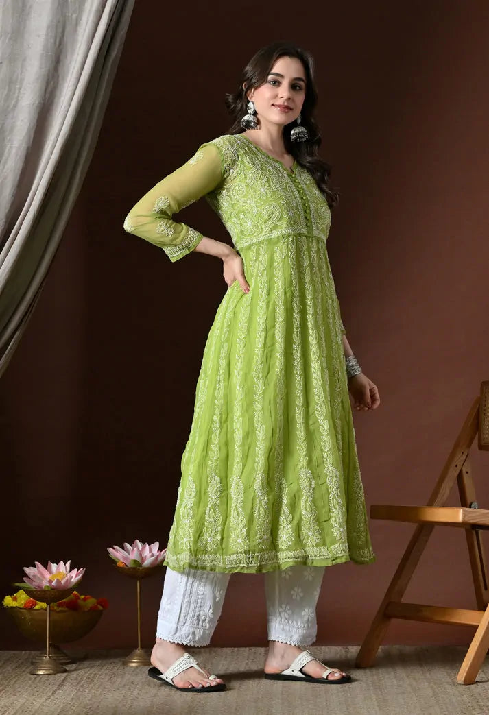 Angled view of pistachio green embroidered kurta set with white pants