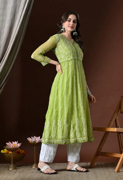 Angled view of pistachio green embroidered kurta set with white pants