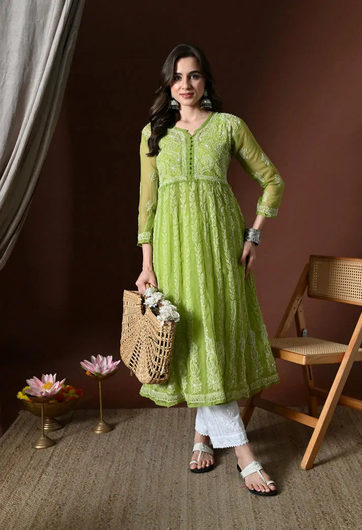 Women's pistachio green anarkali kurta set styled with woven handbag
