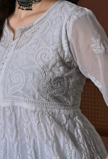 Detailed embroidery work on white Anarkali kurti bodice and sleeves