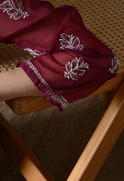 Closeup of embroidered sleeve design on wine colour Anarkali kurti